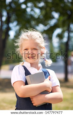 Image of cute girl with book in summer park