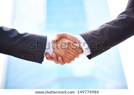 Close-up of business partners shaking hands to do business together