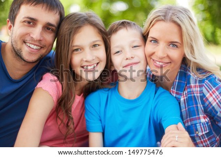 Photo Of Happy Family Of Four Looking At Camera Outdoors