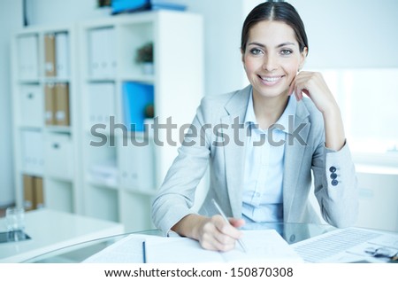 Portrait of an elegant manager sitting at her workplace