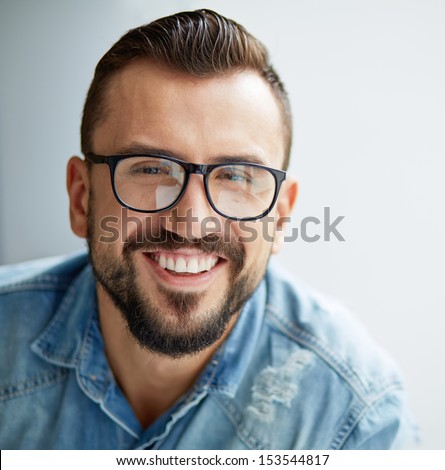 Happy Man In Denim Shirt And Eyeglasses Looking At Camera With Toothy Smile
