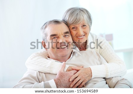Portrait Of A Happy Senior Couple Looking At Camera