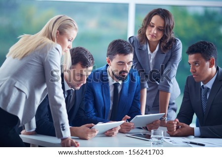 Elegant business partners planning work at meeting Elegant business partners planning work at meeting