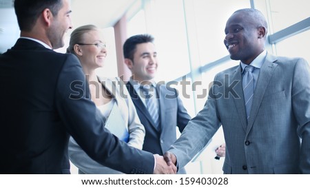 Image Of Businessmen Handshaking On Background Of Their Colleagues