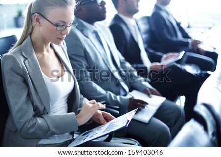 Image of row of business people working at seminar