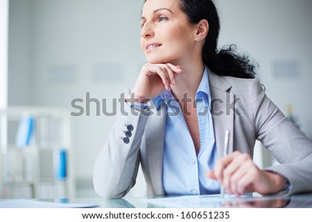 Smiling Businesswoman In Formalwear Sitting At Workplace