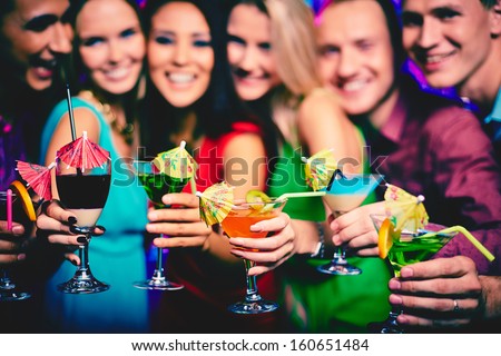 Glasses With Cocktails Held By Happy Friends At Party