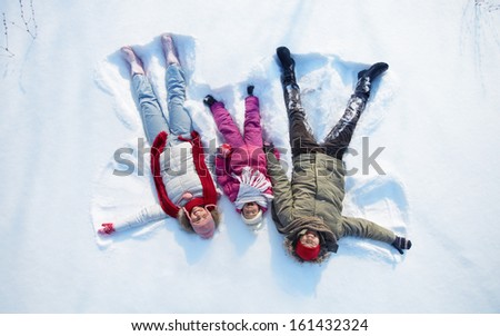 Happy Parents And Their Daughter Having Fun In Snowdrift
