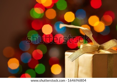 Image of Christmas golden giftbox on sparkling background