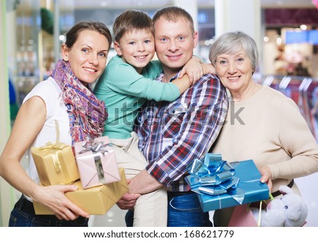 Portrait of family holding giftboxes in the shop