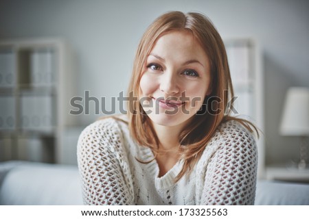 Smiling young woman looking at camera in isolation
