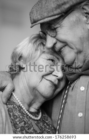 Black-And-White Image Of Senior Couple In Smart Clothes