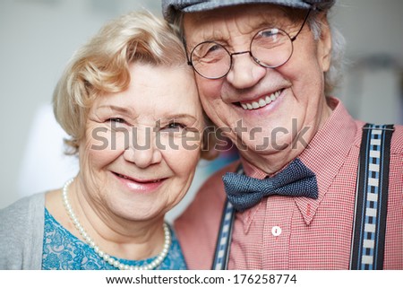 Portrait of senior couple in smart clothes looking at camera