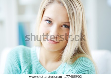 Portrait of a blond girl with a flirty look