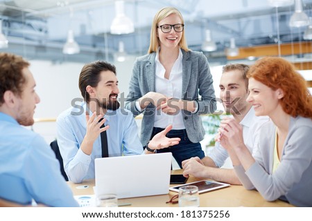 Group of business partners discussing ideas at meeting in office