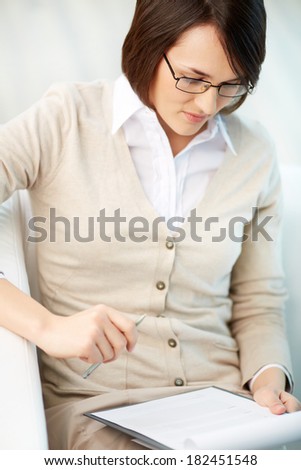 Vertical image of a professional counselor looking at document