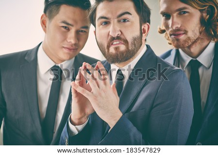 Bearded businessman with evil expression