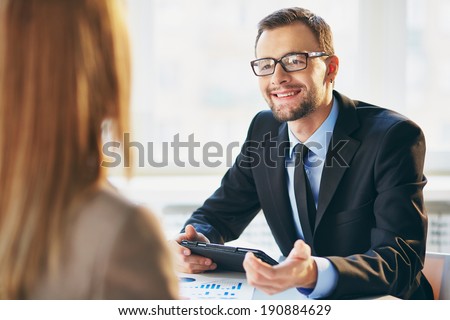 Image of young businessman interviewing female