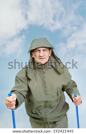 Portrait of mature man in jacket on trip