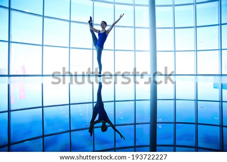 Image of female doing balance and stretching exercise in gym
