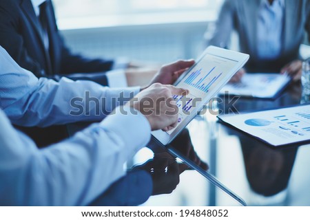 Image of businessman hand pointing at document in touchpad