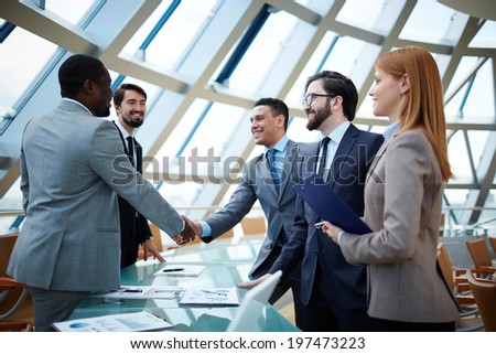 Two businessmen handshaking after striking grand deal