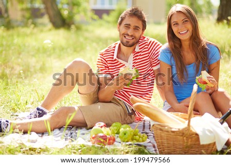 Happy young dates having picnic in the country