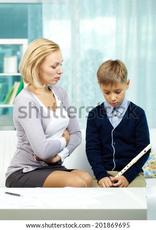 Portrait of annoyed tutor dissatisfied with pupil who is not ready for the lesson of music