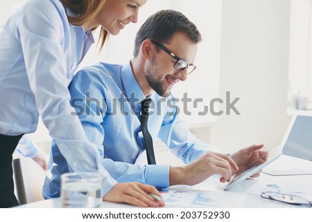 Image of two successful business partners working at meeting in office