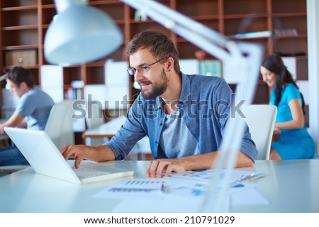 Handsome businessman in casual networking in office