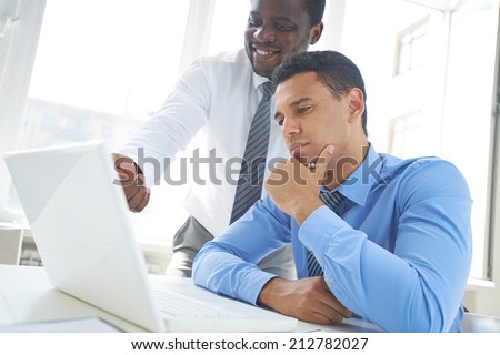 African-american businessman explaining new project to his colleague in office