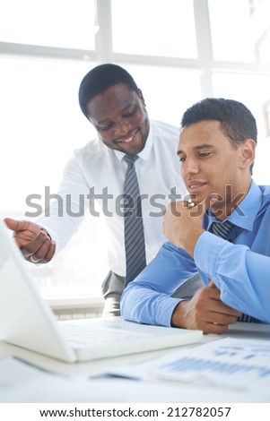 African-american businessman presenting his ideas to colleague at meeting