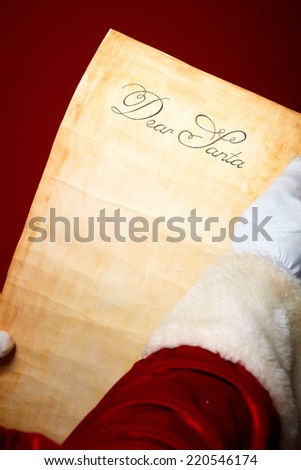 Close-up of Christmas letter held by Santa Claus