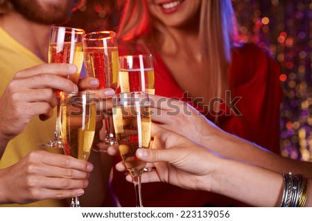 Group of friends toasting with champagne