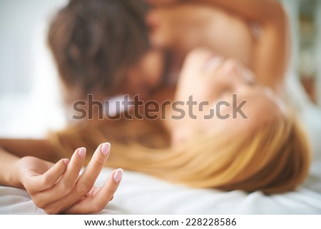 Hand of female caressed by a man