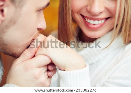 Man kissing female hand