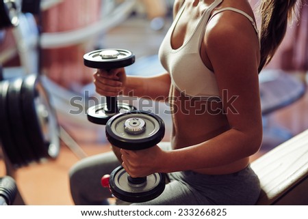 Young woman exercising with weights