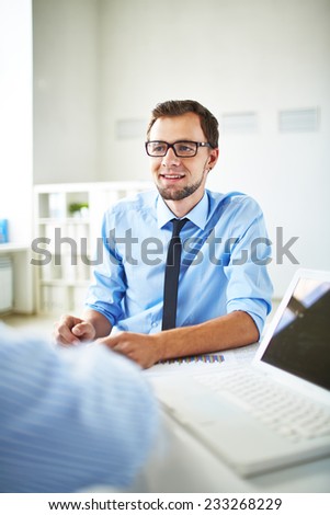 Young office worker in office of leader