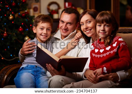 Family of four reading tales on Christmas evening