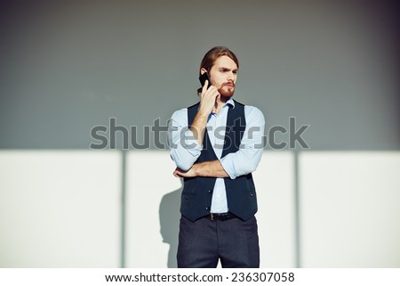 Young handsome businessman calling in isolation