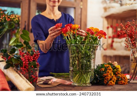 Flower seller putting flowers into a vase
