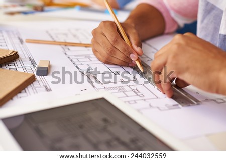 Hands of male architect making sketch
