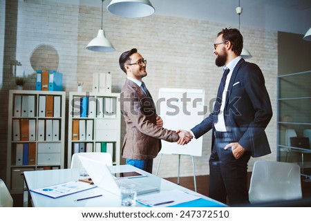 Successful businessmen handshaking after negotiation