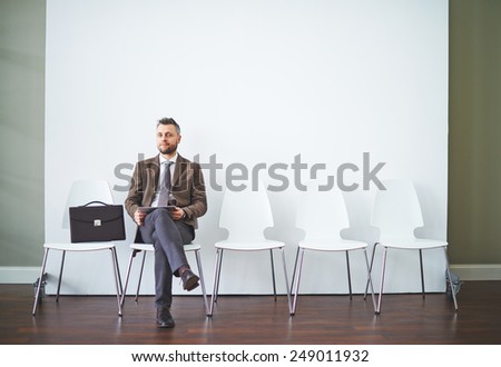 Confident man in formalwear waiting for his turn for interview