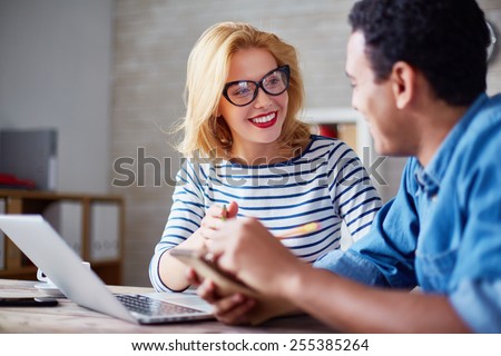 Charming secretary looking at her boss during interaction