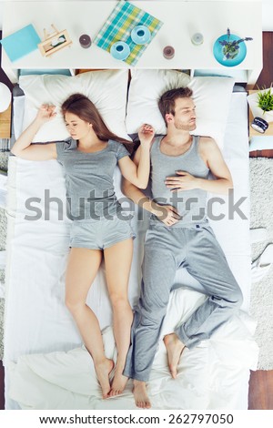 High angle view of people sleeping in bed