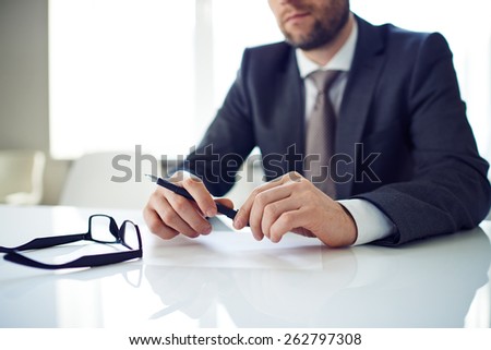 Man with pen thinking about work