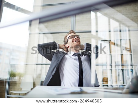 Young businessman dreaming during break in office