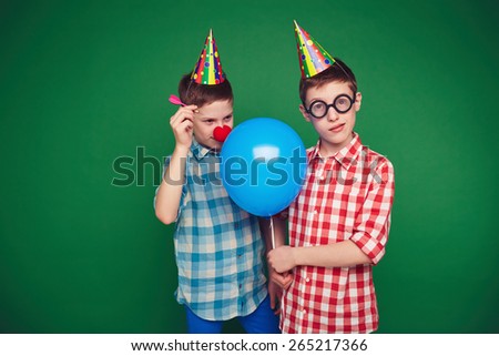 Goofy child going to burst balloon of his brother