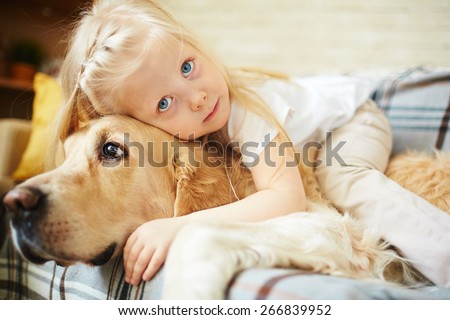 Cute child lying on fluffy pet